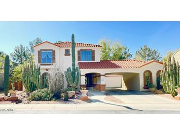 Charming two-story home featuring a terracotta roof, stucco exterior, and desert landscaping at 3807 E Latham Ct, Gilbert, AZ 85297