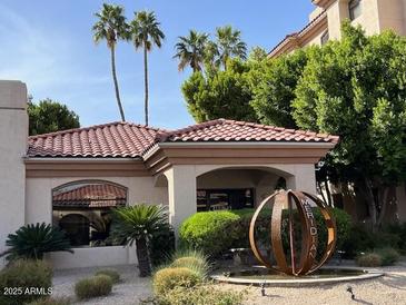 Beautiful building exterior featuring lush landscaping and a unique water feature and monument at 5104 N 32Nd St # 431, Phoenix, AZ 85018