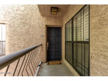 Inviting front door entrance with a welcome mat, and large windows providing natural light at 5122 N 31St Way # 238, Phoenix, AZ 85016