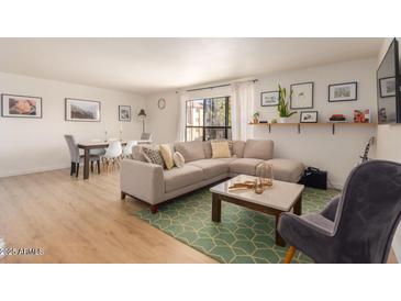 Bright and airy living room featuring a comfortable sofa, modern decor, and an open floor plan at 5122 N 31St Way # 238, Phoenix, AZ 85016
