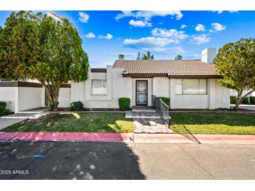 Charming single-story home featuring a well-maintained yard and secure front entry at 8742 E Via De La Luna --, Scottsdale, AZ 85258