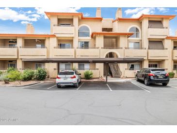 Beautiful condo complex featuring stucco walls, balconies, covered parking, and desert landscaping at 10410 N Cave Creek Rd # 2114, Phoenix, AZ 85020