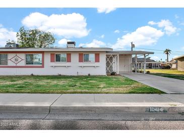 Charming single-story home with a well-manicured lawn and traditional architectural details at 10414 N 105Th Ave, Sun City, AZ 85351
