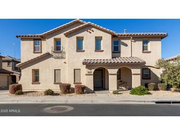 Charming two-story townhome featuring a private entry, desert landscaping, and a tile roof at 16610 W Culver St, Goodyear, AZ 85338