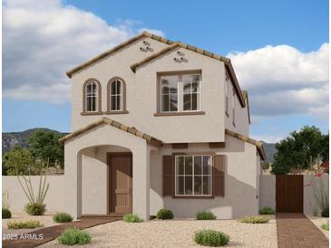 Charming two-story home with a tan stucco exterior, arched entry, and tile roof at 1974 W Lariat Ln, Phoenix, AZ 85085