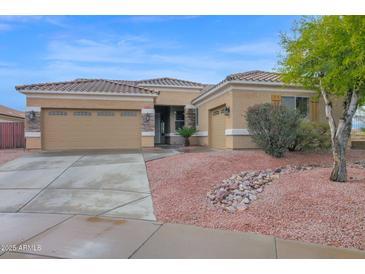 Charming single-story home featuring a well-manicured yard and a two-car garage in a peaceful neighborhood at 26506 N 74Th Ln, Peoria, AZ 85383