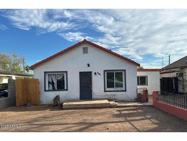 Charming single-story home featuring a red roof, stucco siding, and a small front yard at 2912 E Monroe St, Phoenix, AZ 85034