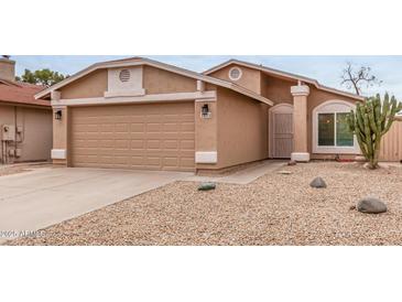 Inviting home with a two-car garage and desert landscaping, offering curb appeal and easy maintenance at 3613 W Camino Real --, Glendale, AZ 85310