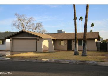 Charming single-story home with a two-car garage and xeriscaped front yard at 419 E Gemini Dr, Tempe, AZ 85283