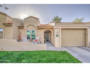 Charming home with well-maintained lawn, patio seating, and a convenient attached garage at 1021 S Greenfield Rd # 1178, Mesa, AZ 85206