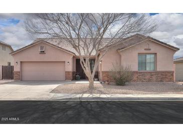 Charming single-story home with well-maintained landscaping and a two-car garage at 1629 E Prickly Pear Pl, Casa Grande, AZ 85122