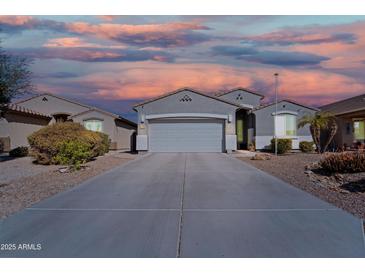 Charming single-Gathering home with a two-car garage, desert landscaping, and a long driveway at 1700 W Paisley Dr, San Tan Valley, AZ 85144