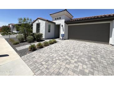 Beautiful home featuring a paver driveway, two-car garage, desert landscaping, and a neutral color scheme at 17168 W Middlebury St, Surprise, AZ 85388