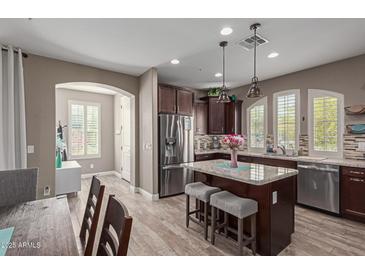 Well-appointed kitchen with an island, stainless steel appliances, and abundant counter space at 20539 W Terrace Ln, Buckeye, AZ 85396