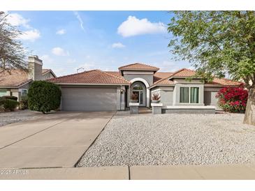 Charming single-story home featuring a well-maintained front yard and a spacious two-car garage at 2906 E Nora St, Mesa, AZ 85213