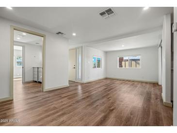Bright living room featuring wood-look flooring, neutral walls, and natural light at 3104 E Broadway Rd -- # 287, Mesa, AZ 85204