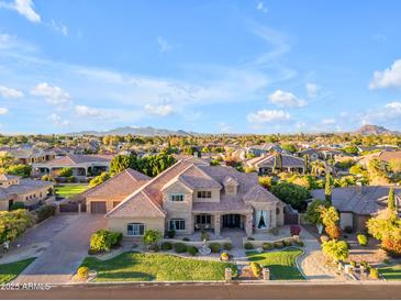Luxury home with manicured landscaping, mature trees and hardscape in a lush desert neighborhood at 3446 E Knoll St, Mesa, AZ 85213