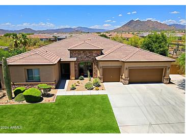Beautiful single-story home featuring a three-car garage, desert landscaping and gorgeous mountain views at 6044 E Hodges St, Cave Creek, AZ 85331