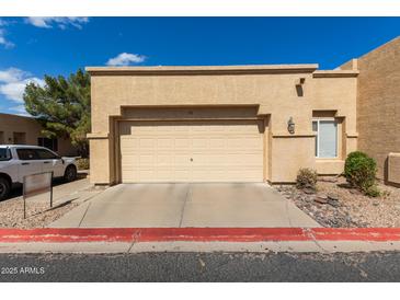 Beige two-car garage attached to a single-story home with desert landscaping and a red painted curb at 625 N Hamilton St # 36, Chandler, AZ 85225