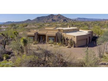 Lovely stucco home with desert landscaping and mountain views at 7603 E Soaring Eagle Way, Scottsdale, AZ 85266