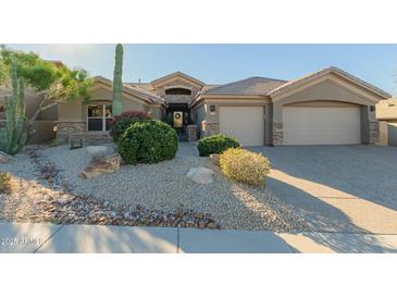 Charming single-story home featuring desert landscaping and a three-car garage, providing ample parking space at 14741 E Mountain Majesty --, Fountain Hills, AZ 85268