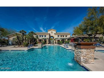 Beautiful community pool with stone pillar water features and inviting lounge areas at 16013 S Desert Foothills Pkwy # 1133, Phoenix, AZ 85048