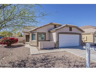 Charming single-story home with a desert landscape and a two car garage under a bright blue sky at 1615 W Hidalgo Ave, Phoenix, AZ 85041