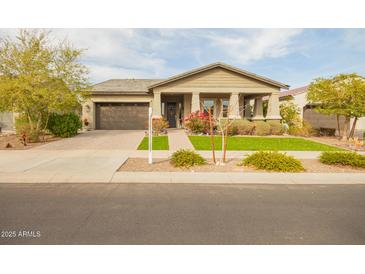 Charming home with a two-car garage, well-maintained landscaping, and a welcoming front porch at 20652 W Clearstream Dr, Buckeye, AZ 85396