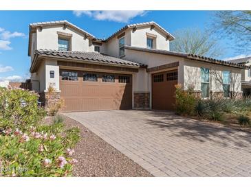 Beautiful two-story home featuring a three-car garage and desert landscaping at 2423 N Beverly Pl, Buckeye, AZ 85396