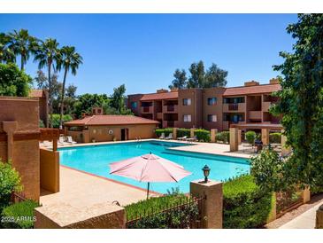 Enjoy the community pool surrounded by lush landscaping and resort-style living at 3031 N Civic Center Plz # 205, Scottsdale, AZ 85251