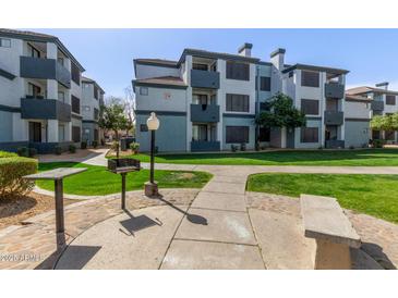 Inviting apartment complex with lush green spaces and community barbeque area at 3848 N 3Rd Ave # 1047, Phoenix, AZ 85013