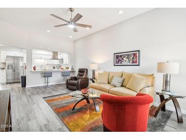Open floor plan featuring kitchen, breakfast bar, and living room at 9926 W Lancaster Dr, Sun City, AZ 85351