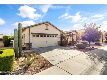 Charming single-story home with a two-car garage, desert landscaping, and a well-maintained front yard at 22419 W La Pasada Blvd, Buckeye, AZ 85326