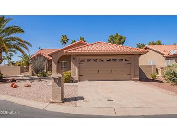 Charming single-story home features a neutral color palette, desert landscaping, and two-car garage at 24832 S Boxwood Dr, Sun Lakes, AZ 85248