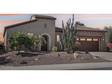 Charming home with desert landscaping including mature cactus and rock detail around the property at 29534 N 128Th Ln, Peoria, AZ 85383