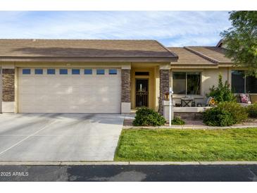 Charming single-story home featuring a two-car garage, covered entry, and well-maintained landscaping at 2662 S Springwood Blvd # 341, Mesa, AZ 85209