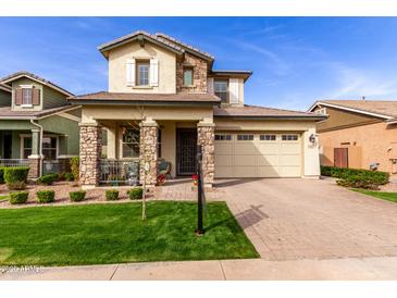 Charming two-story home with stone accents, manicured lawn, and inviting curb appeal at 3522 E Spring Wheat Ln, Gilbert, AZ 85296