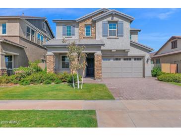 Charming two-story home with a manicured lawn, stone accents, and a two-car garage at 3830 E Appaloosa Rd, Gilbert, AZ 85296