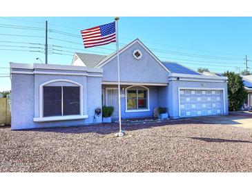Charming single-story home with a well-maintained yard and a prominent American flag at 4631 W Mcrae Way, Glendale, AZ 85308
