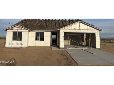New construction home featuring a two-car garage and a clean, modern design in a desert landscape at 5981 N Nigal Rd, Casa Grande, AZ 85194