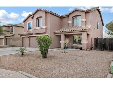 Two-story home with neutral stucco, tiled roof, and a desert landscape at 28014 N Jade St, San Tan Valley, AZ 85143