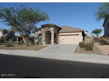 Charming single-story home featuring a well-manicured lawn and a two car garage at 29673 N 120Th Ln, Peoria, AZ 85383