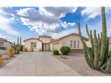 Charming single-story home features desert landscaping and a spacious driveway, perfect for suburban living at 32160 N Dog Leg Ct, San Tan Valley, AZ 85143