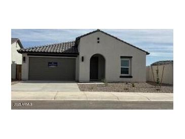 Charming single-story home featuring a neutral color palette, tile roof, and attached two-car garage at 36971 W Santa Maria St, Maricopa, AZ 85138