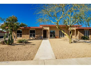 Charming single-story home featuring desert landscaping and a welcoming walkway at 13226 N Cedar Dr, Sun City, AZ 85351