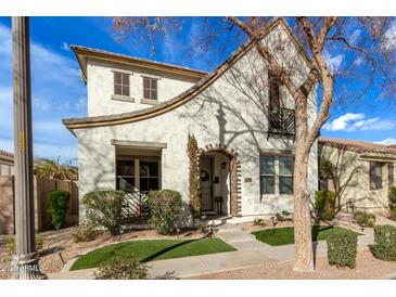Charming two-story home with a stucco exterior, well-manicured landscaping, and a cozy front porch at 3438 E Betsy Ln, Gilbert, AZ 85296