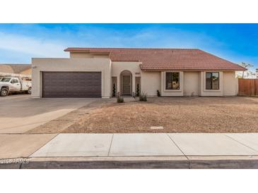 Charming single-Gathering home with a well-maintained front yard and a two-car garage at 5607 E Enrose St, Mesa, AZ 85205