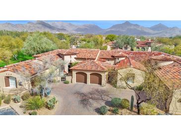 Stunning aerial view of home with mountain views, tile roof, desert landscaping, and private two car garage at 8965 E Mountain Spring Rd, Scottsdale, AZ 85255