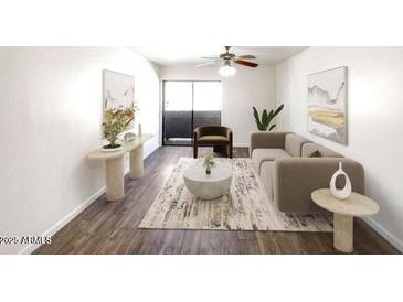 Cozy living room with a ceiling fan, modern furniture, art and access to a balcony at 985 N Granite Reef Rd # 134, Scottsdale, AZ 85257