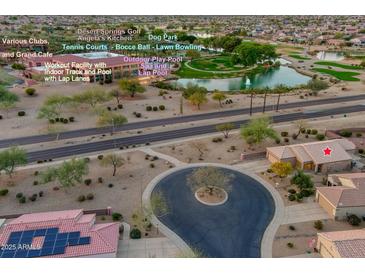 Beautiful aerial view of community amenities including a pool, spa, tennis courts, and desert landscaping at 15848 W Lahlum Ln, Surprise, AZ 85374